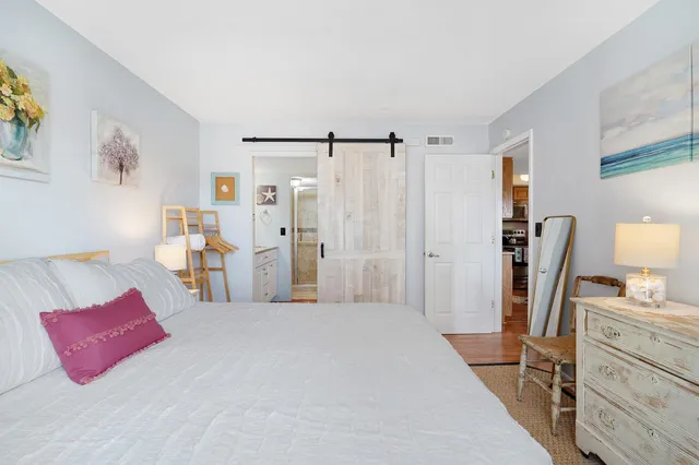 a bathroom with a granite countertop sink a toilet and a mirror