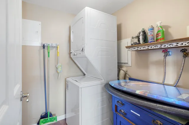 a view of a chairs and table in patio with a lake view