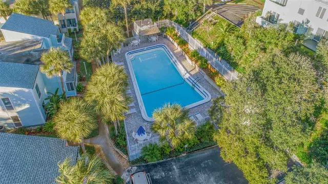 a view of swimming pool with a patio and fire pit