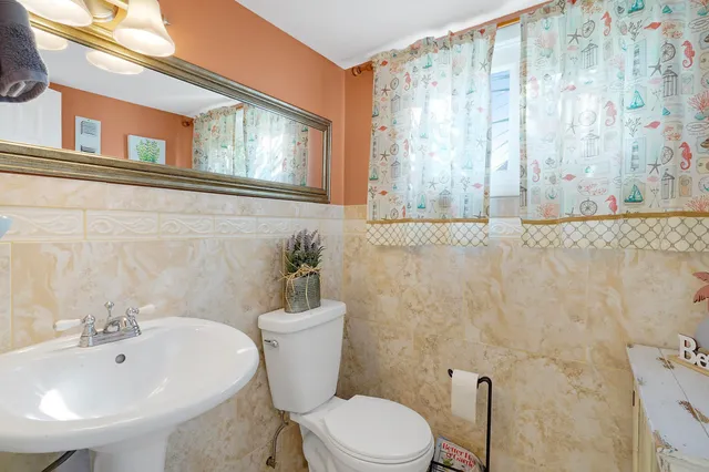 a white toilet sitting next to a bathroom sink