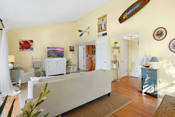 a living room with furniture and a wooden floor