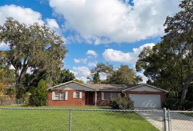 a front view of a house with a garden and yard