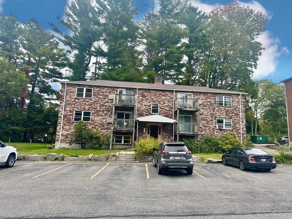 44 Burnap Road, Unit 1 Holliston, MA 01746 - Photo 1 of 17 a car parked in front of a house