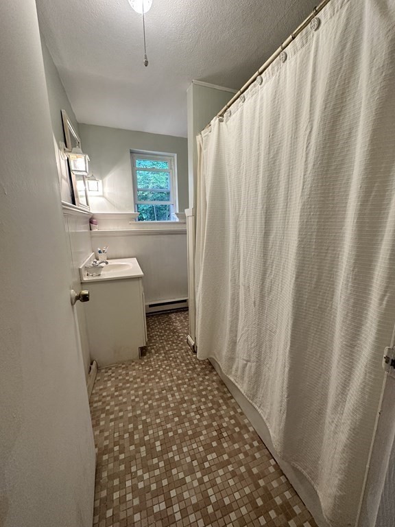 44 Burnap Road, Unit 1 Holliston, MA 01746 - Photo 12 of 17 a bathroom with a sink toilet and window