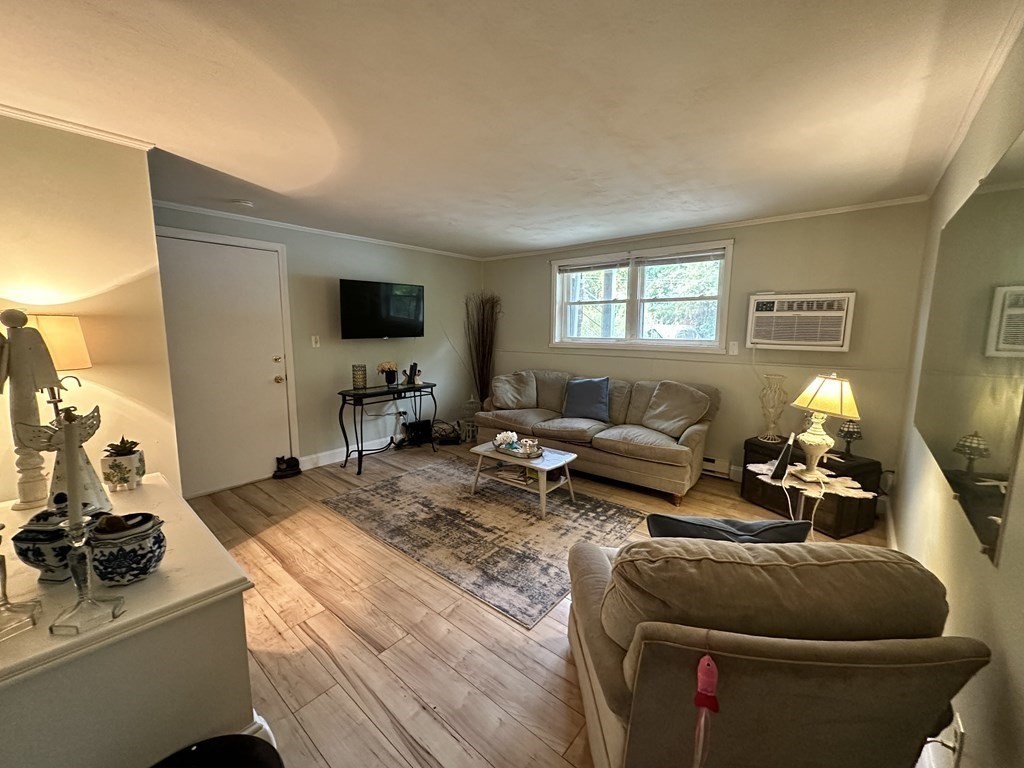 44 Burnap Road, Unit 1 Holliston, MA 01746 - Photo 4 of 17 a living room with furniture and a flat screen tv