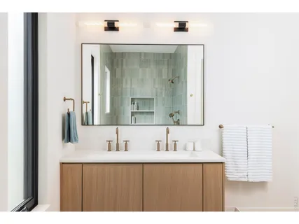 a bathroom with a sink vanity and mirror