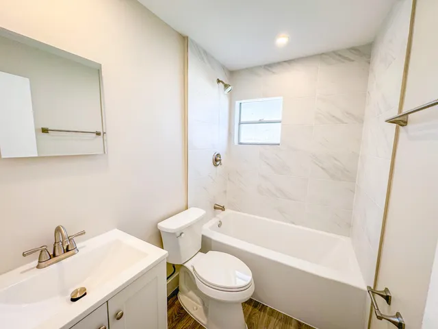 a bathroom with a sink toilet and shower