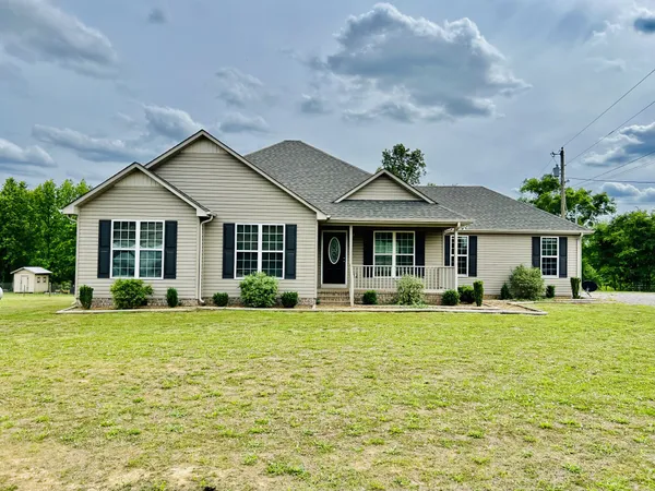 a front view of a house with a garden and porch