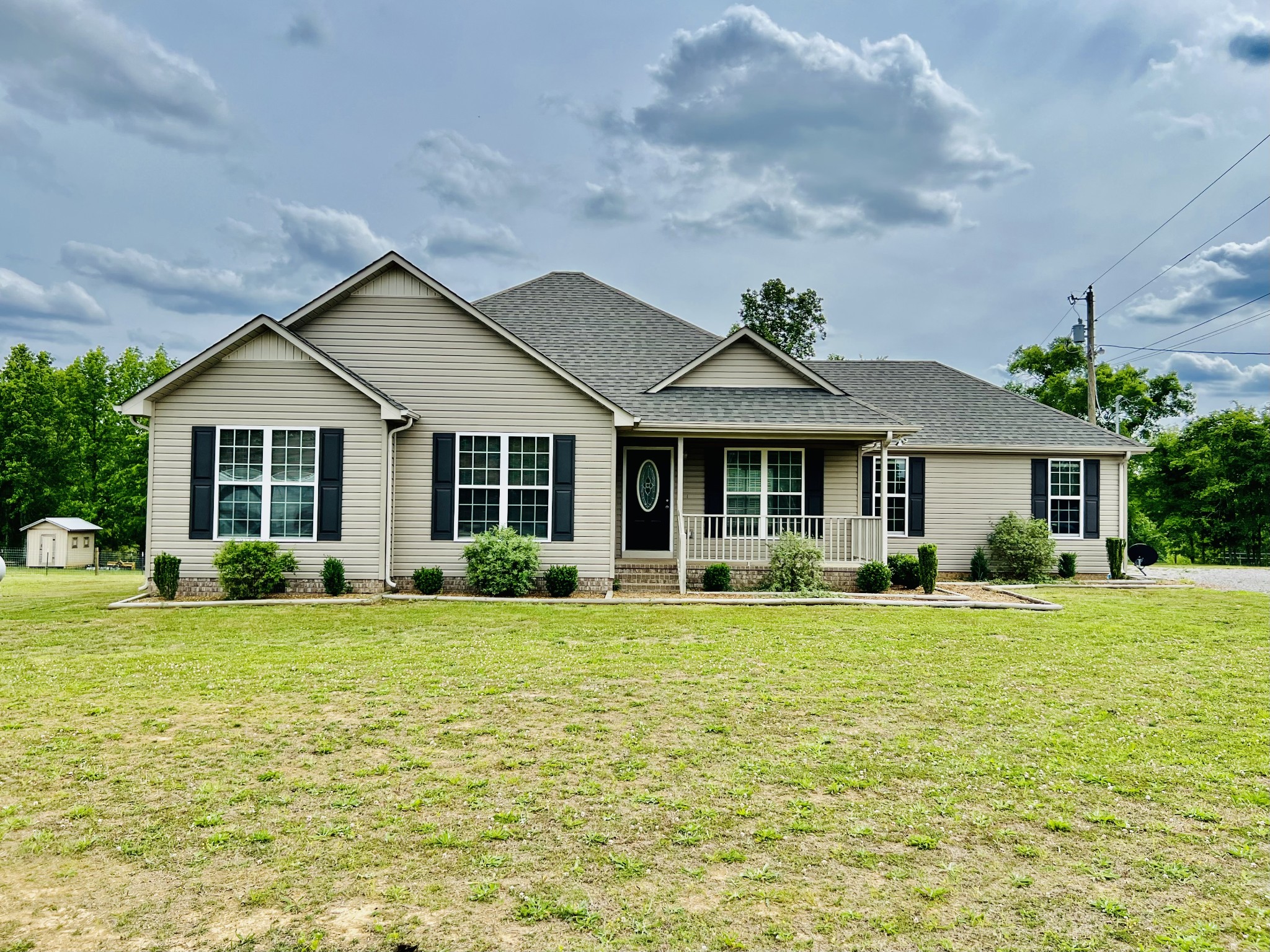 a front view of a house with a garden and porch