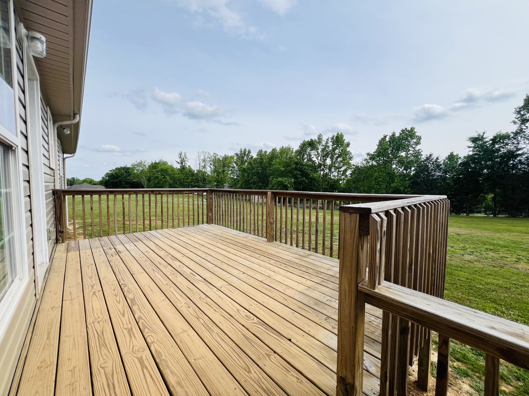 4861 Little Dry Creek Road Pulaski, TN 38478 - Photo 3 of 30 a view of deck with wooden floor and fence next to a yard