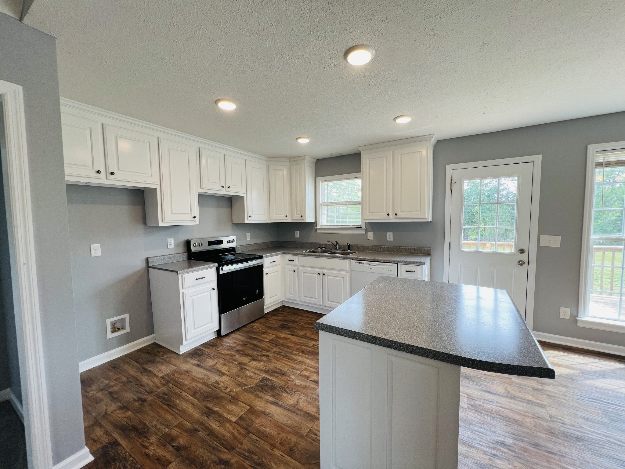 4861 Little Dry Creek Road Pulaski, TN 38478 - Photo 5 of 30 a kitchen with granite countertop a stove top oven sink and cabinets