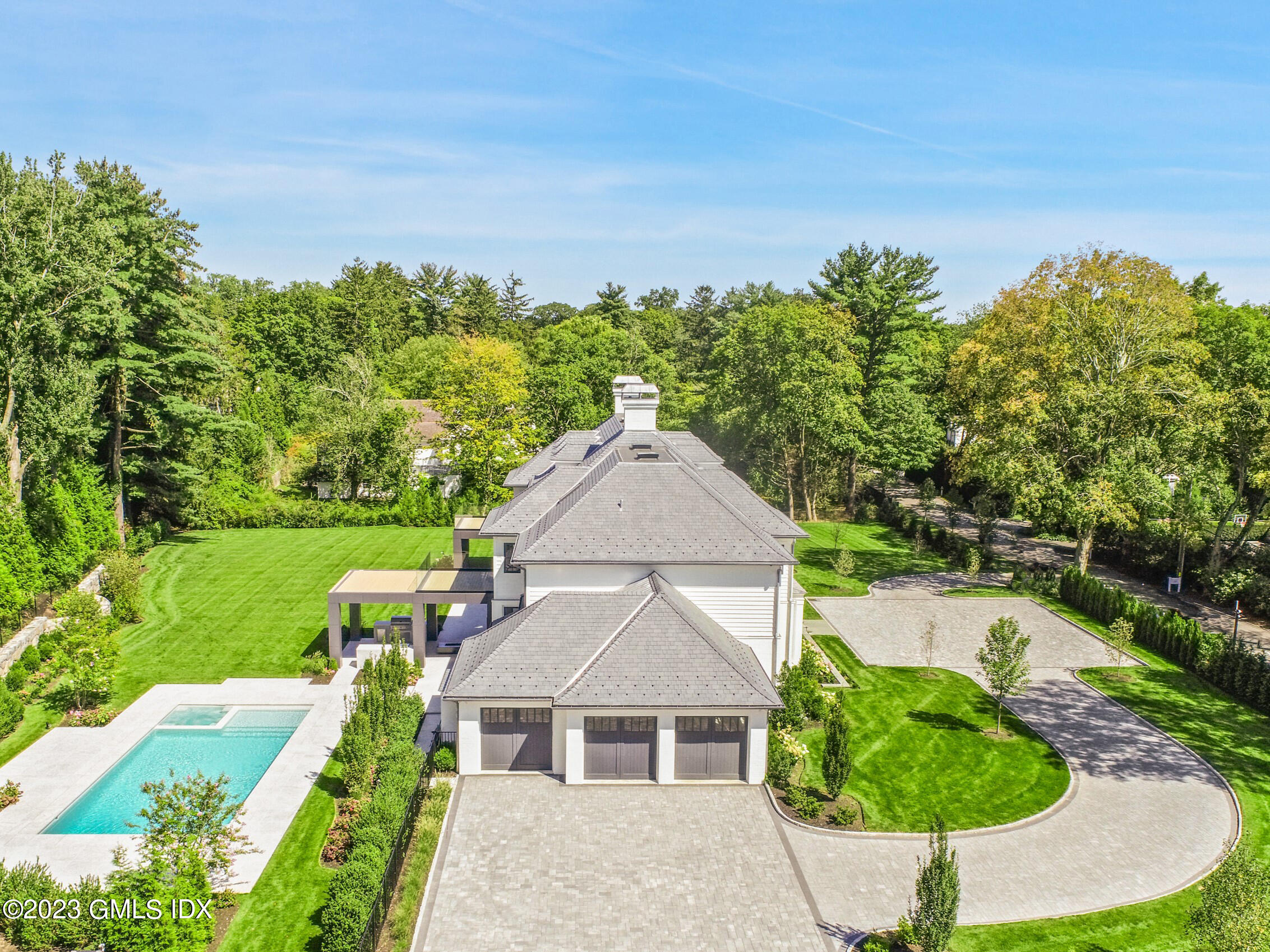 2 Midwood Road Greenwich, CT 06830 - Photo 11 of 12 a view of a house with a yard and sitting area