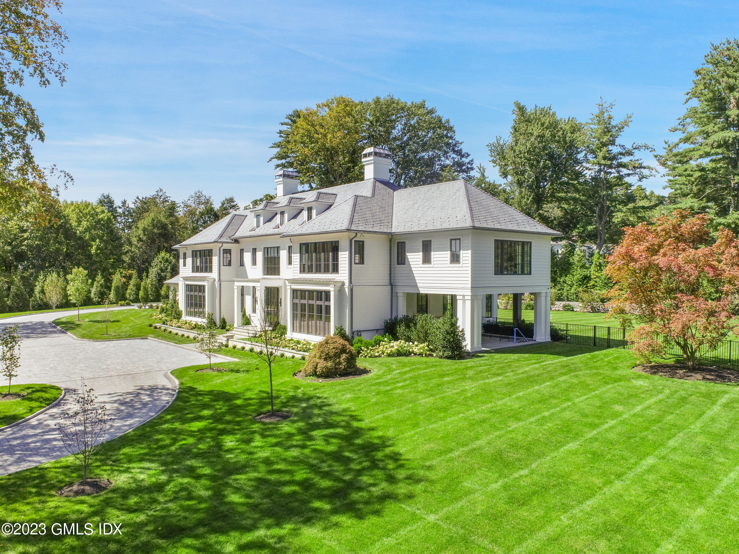 2 Midwood Road Greenwich, CT 06830 - Photo 2 of 12 a front view of a house with a garden
