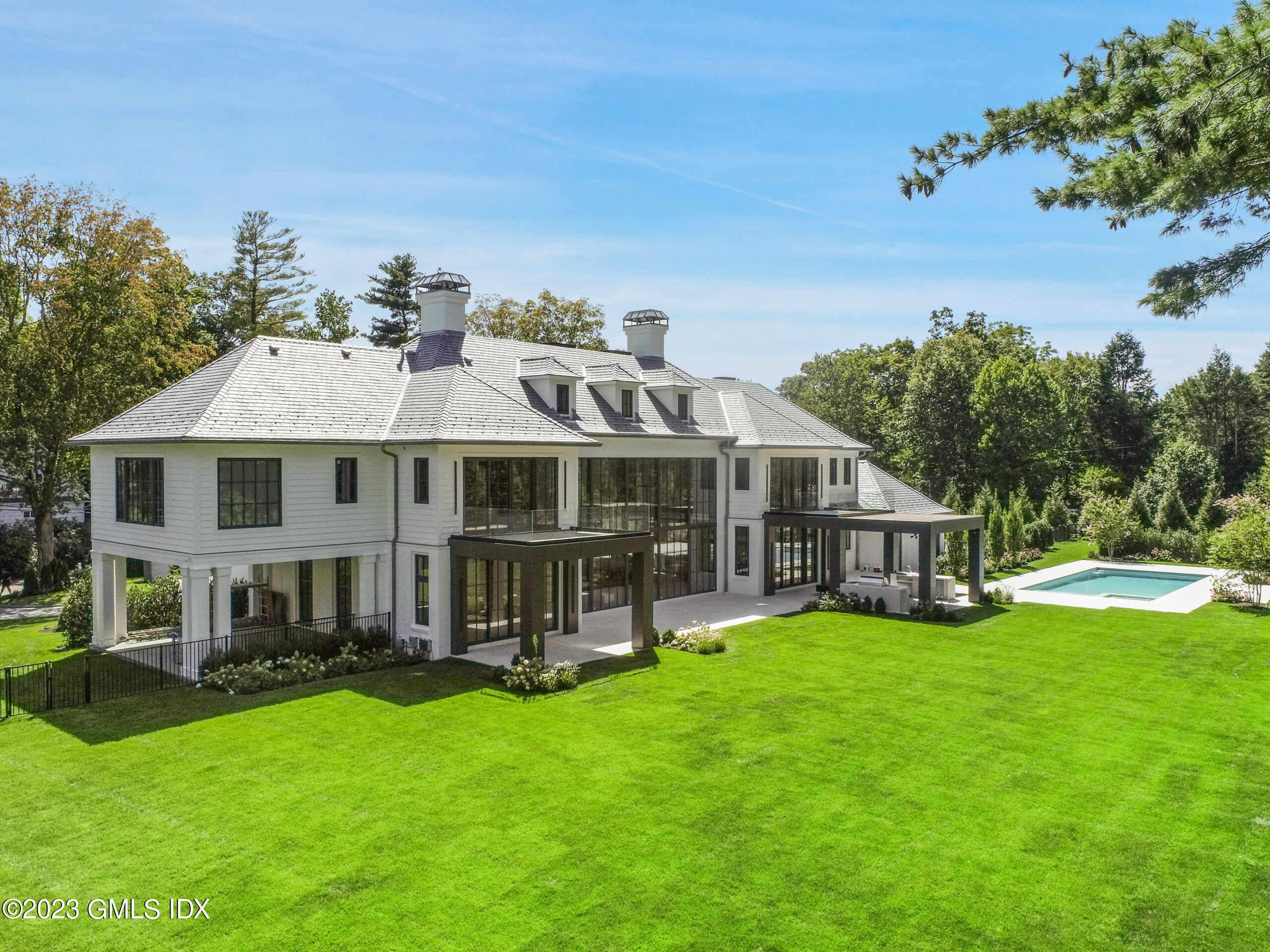 2 Midwood Road Greenwich, CT 06830 - Photo 3 of 12 a aerial view of a house with a yard table and chairs