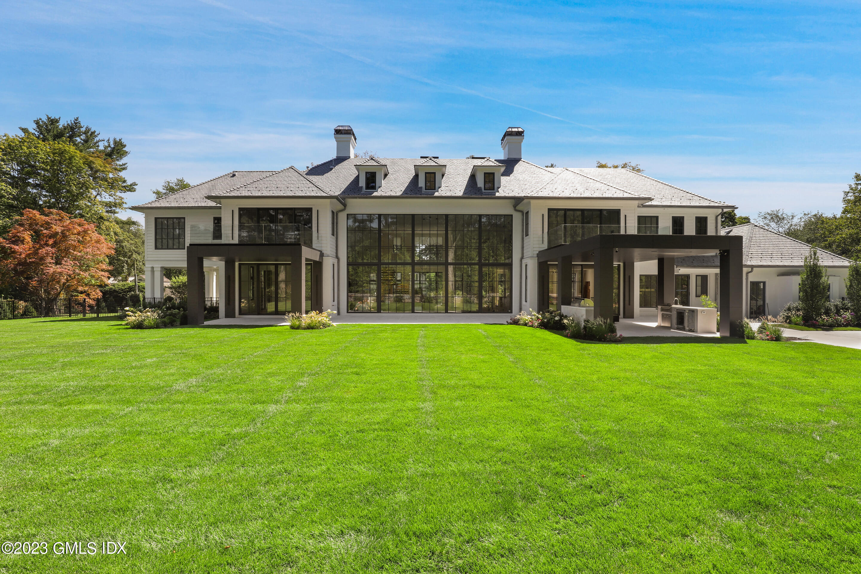 2 Midwood Road Greenwich, CT 06830 - Photo 4 of 12 a front view of a house with a yard