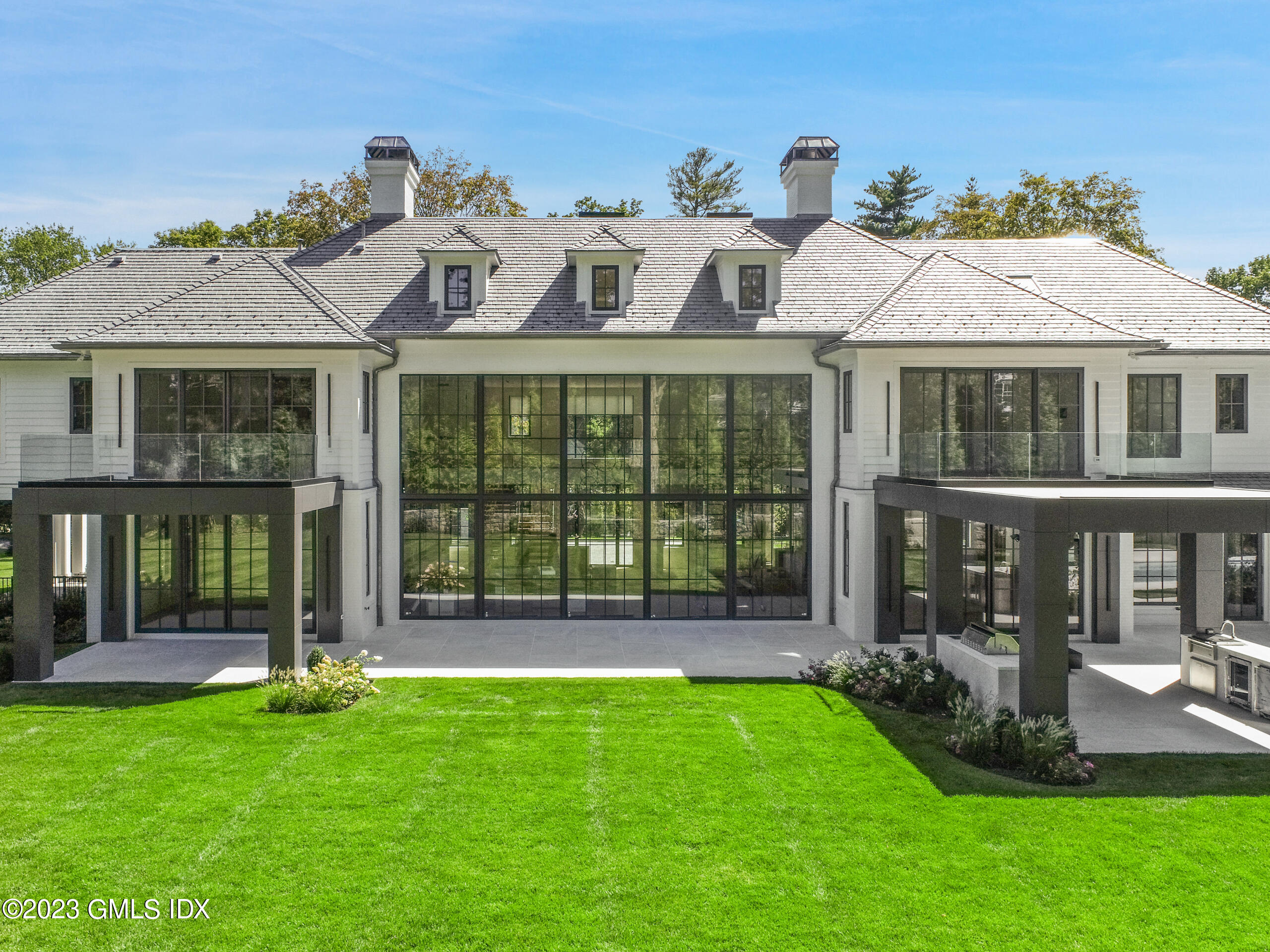 2 Midwood Road Greenwich, CT 06830 - Photo 5 of 12 a front view of a house with a yard