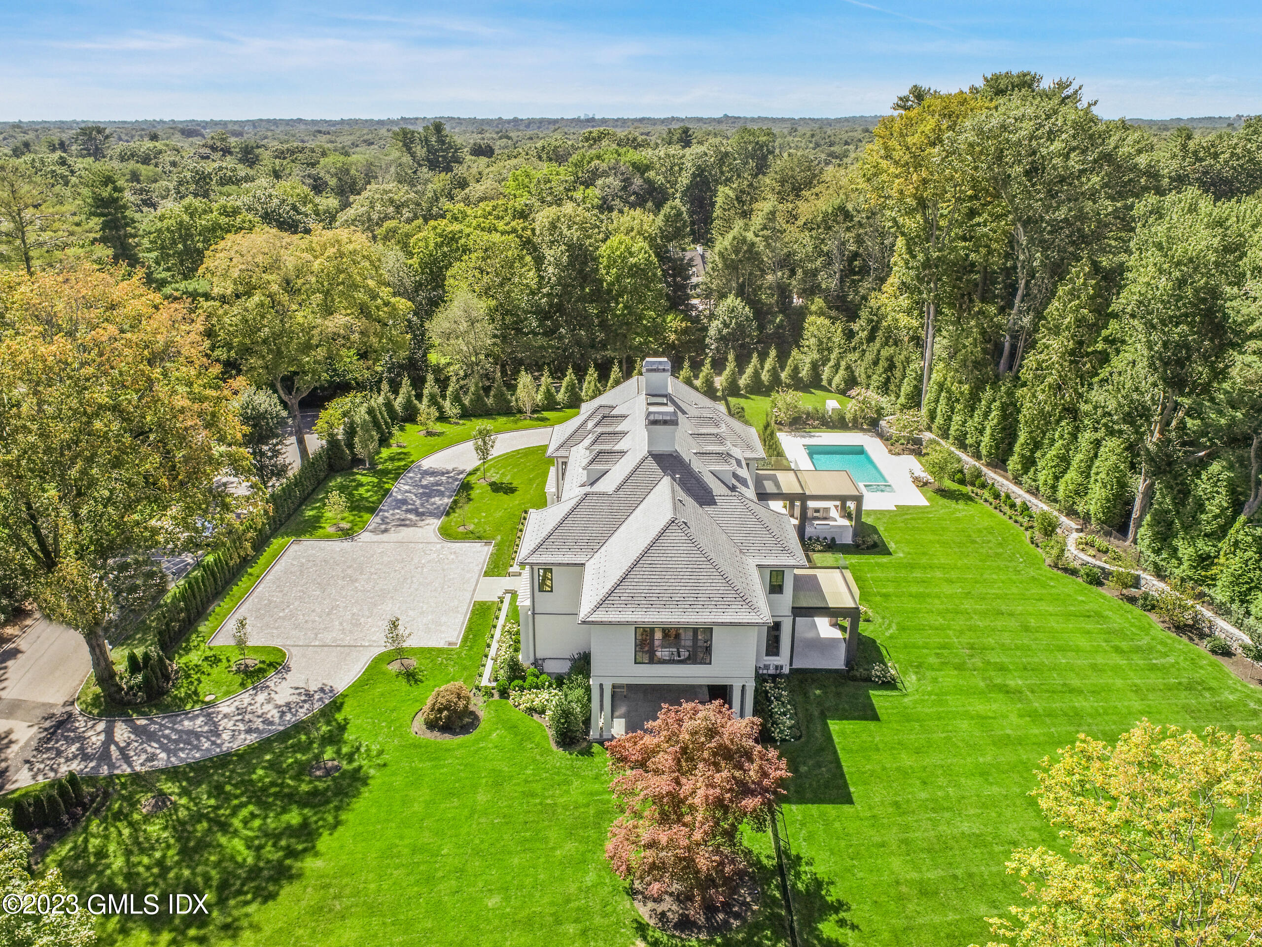2 Midwood Road Greenwich, CT 06830 - Photo 10 of 12 a view of a garden with a building in the background