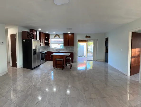 a view of kitchen with refrigerator and furniture