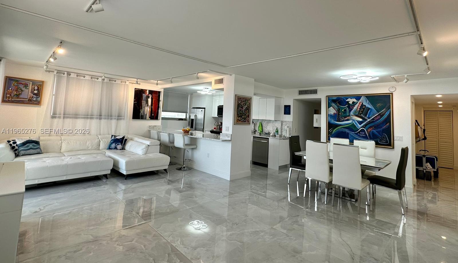 9273 Collins Avenue, Unit 412 Surfside, FL 33154 - Photo 5 of 10 a living room with furniture and view of kitchen