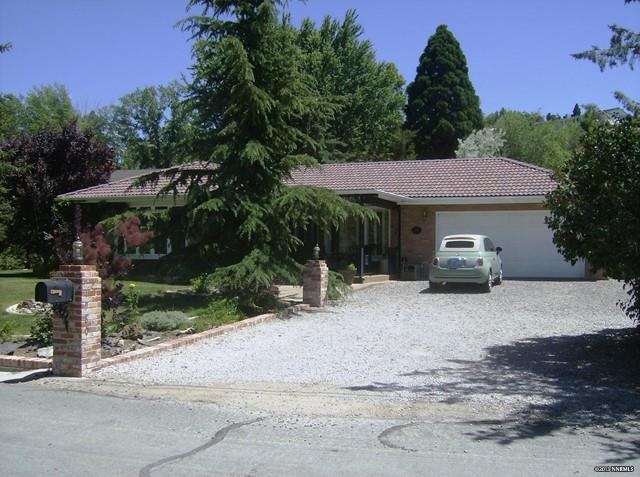 1980 Carter Drive Reno, NV 89509 - Photo 1 of 1 a front view of a house with a yard and trees
