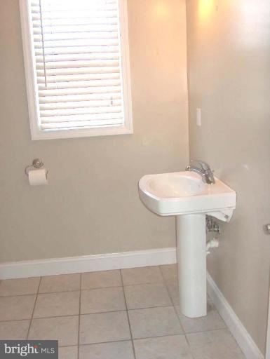 48680 Trapp Road St. Inigoes, MD 20684 - Photo 8 of 13 a bathroom with a sink a window and a shower