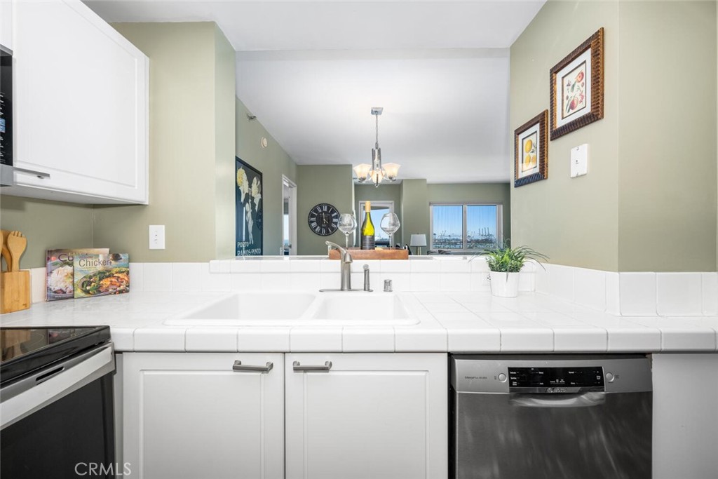 525 East Seaside Way, Unit 904 Long Beach, CA 90802 - Photo 13 of 58 a view of a kitchen counter top space with stainless steel appliances granite countertop a stove and a sink