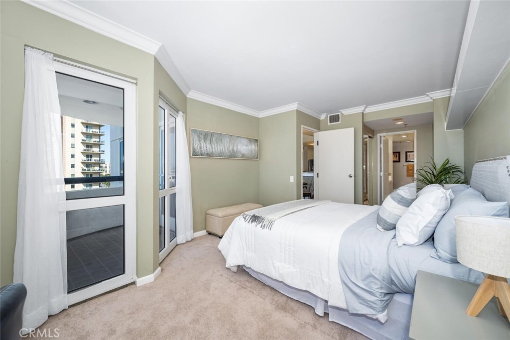 525 East Seaside Way, Unit 904 Long Beach, CA 90802 - Photo 17 of 58 a bedroom with a bed and a mirror