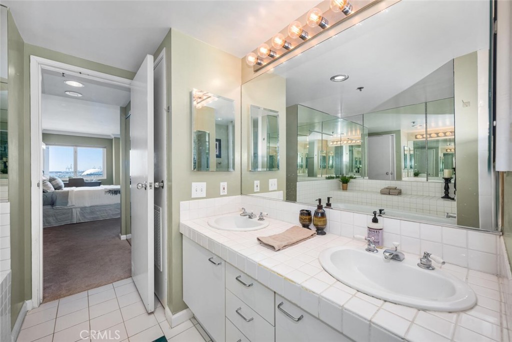 525 East Seaside Way, Unit 904 Long Beach, CA 90802 - Photo 21 of 58 a en suite bathroom with a double vanity sink and mirror