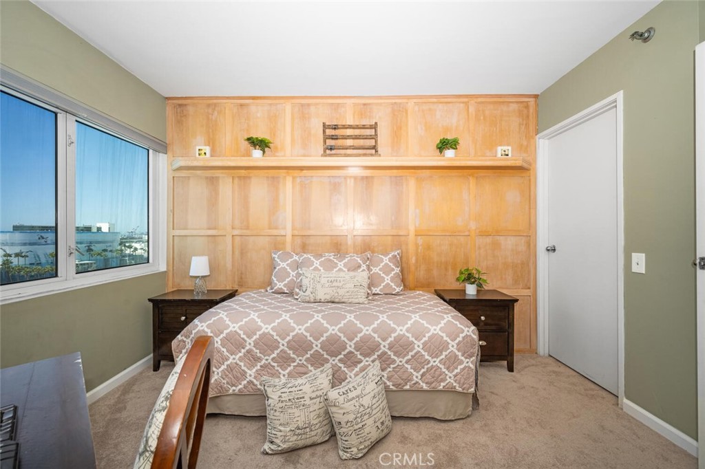 525 East Seaside Way, Unit 904 Long Beach, CA 90802 - Photo 26 of 58 a bedroom with a bed and a window with kitchen view