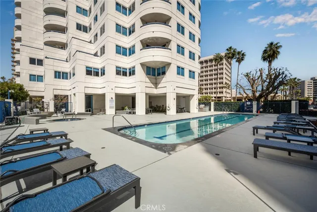 a view of a swimming pool with seating space