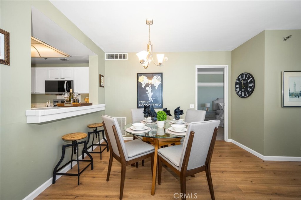 525 East Seaside Way, Unit 904 Long Beach, CA 90802 - Photo 9 of 58 a view of a dining room with furniture window and wooden floor