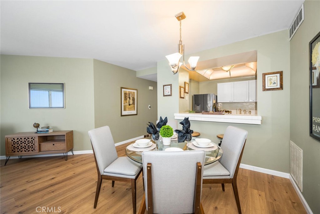 525 East Seaside Way, Unit 904 Long Beach, CA 90802 - Photo 10 of 58 a view of a dining room with furniture and wooden floor