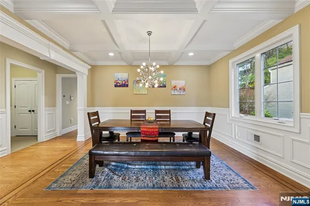 a view of a a dining room with furniture window and wooden floor