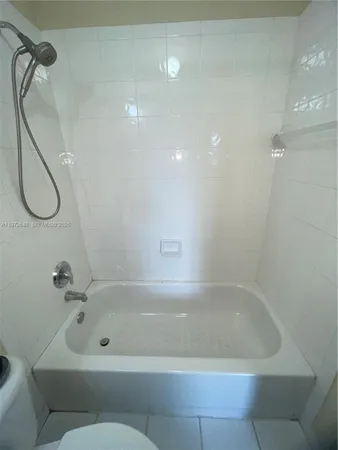 a bath tub sitting next to a shower