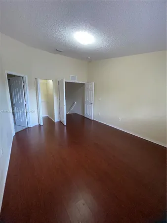 a view of an empty room and wooden floor