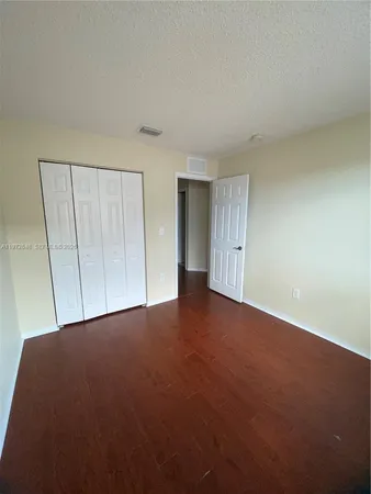 a view of an empty room and closet area