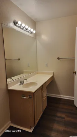 a utility room with cabinets and wooden floor