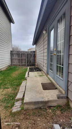 a view of a house with backyard and porch