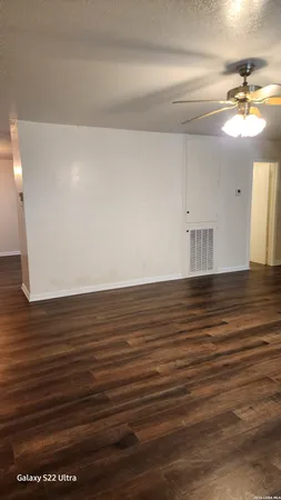 a view of a room with wooden floor