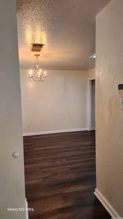 a view of a room with wooden floor