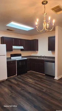 a kitchen with stainless steel appliances a sink and a refrigerator