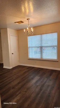 a view of wooden floor and windows in a room
