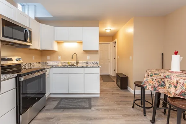 a kitchen with a sink cabinets and stainless steel appliances