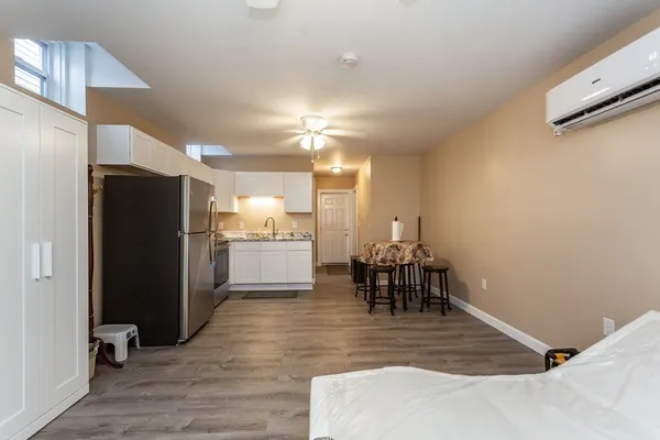 a kitchen with a refrigerator and a dining table