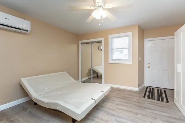 a bedroom with a bed and a window