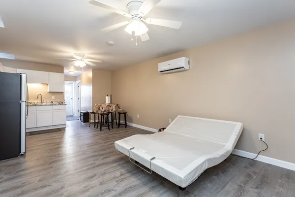 a living room with dining room and wooden floor