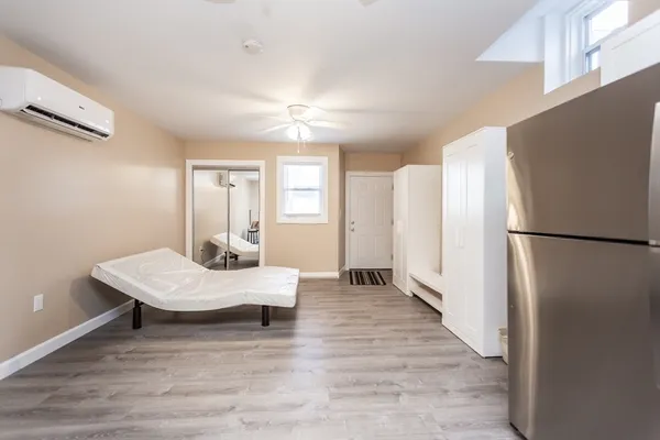 a room with a bed furniture and wooden floor