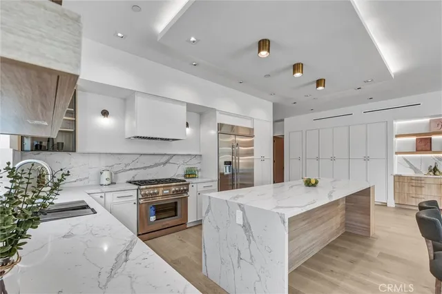 a kitchen with a stove sink and cabinets