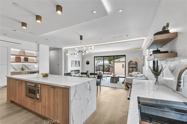 a open kitchen with stainless steel appliances granite countertop a stove and cabinets