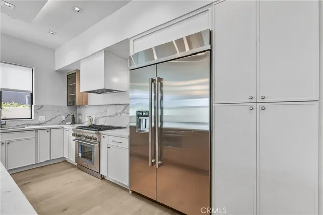 a kitchen with a refrigerator a sink and cabinets